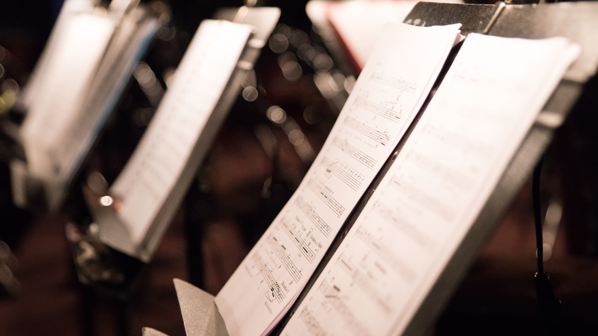 Open book of sheet music in a dimly lit room